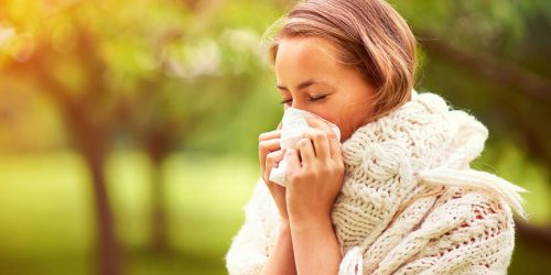 woman blowing her nose