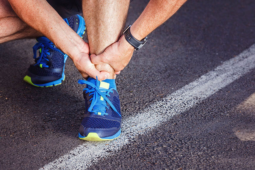 man holding ankle