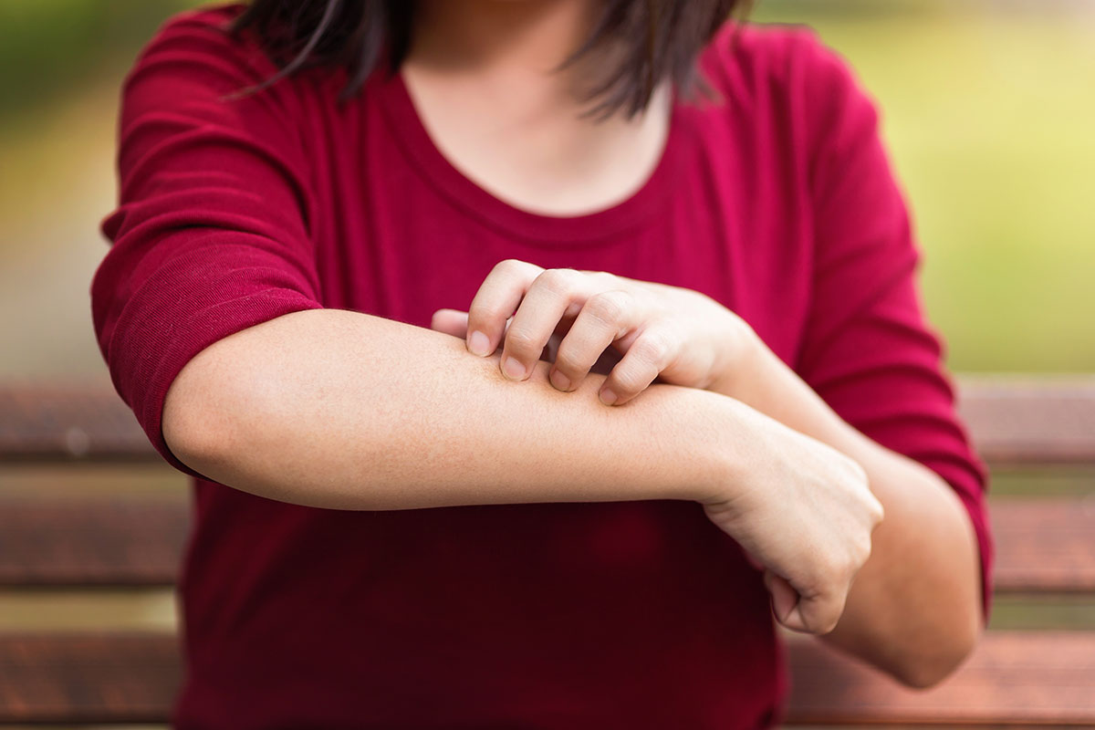 woman holding arm